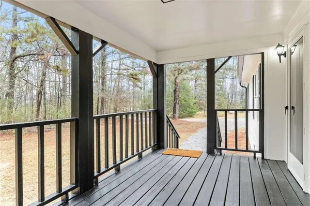 a view of hallway with wooden floor and furniture