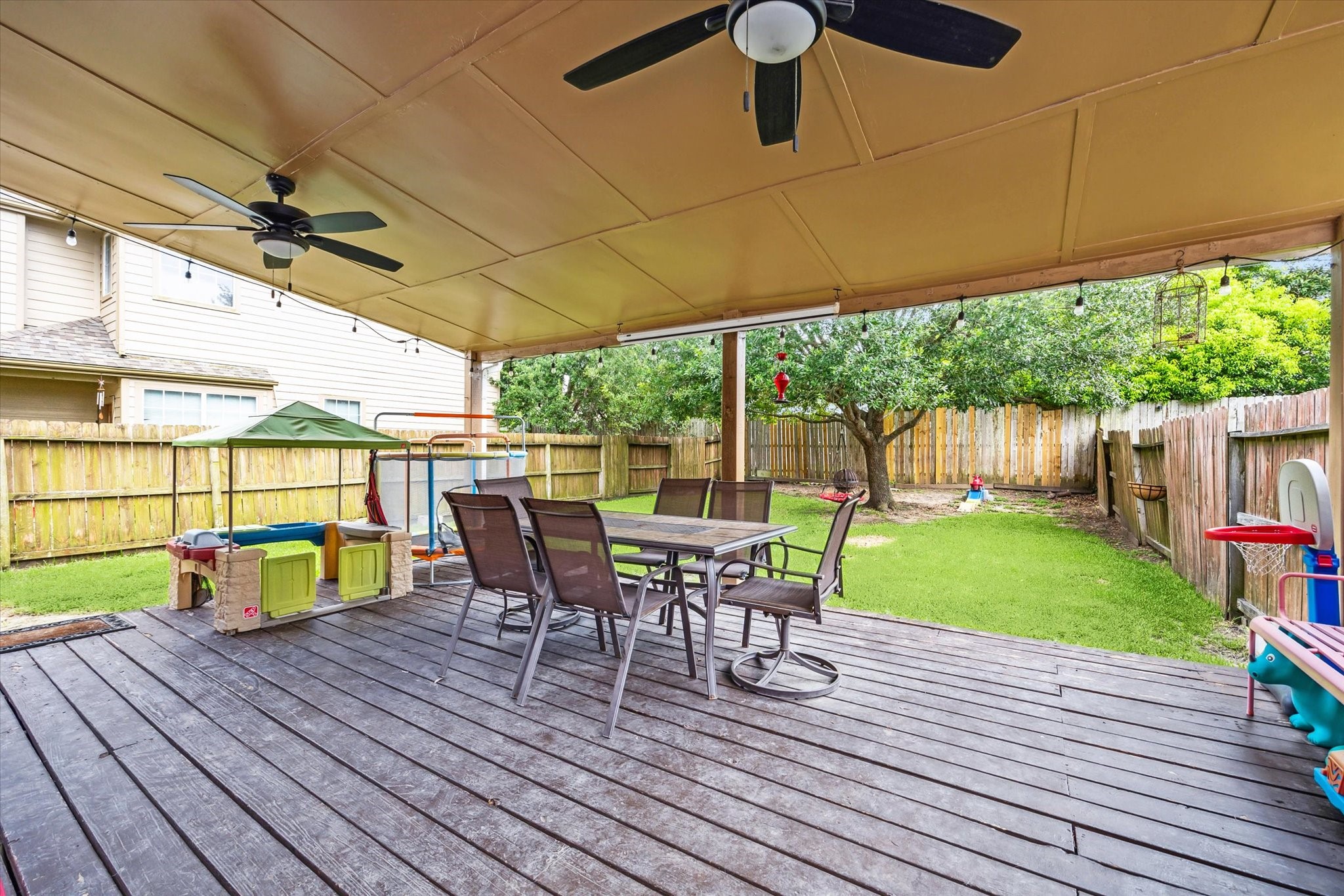 225 Drake Run Lane Dickinson, TX 77539 - Photo 21 of 22 a view of a patio with table and chairs potted plants with wooden floor