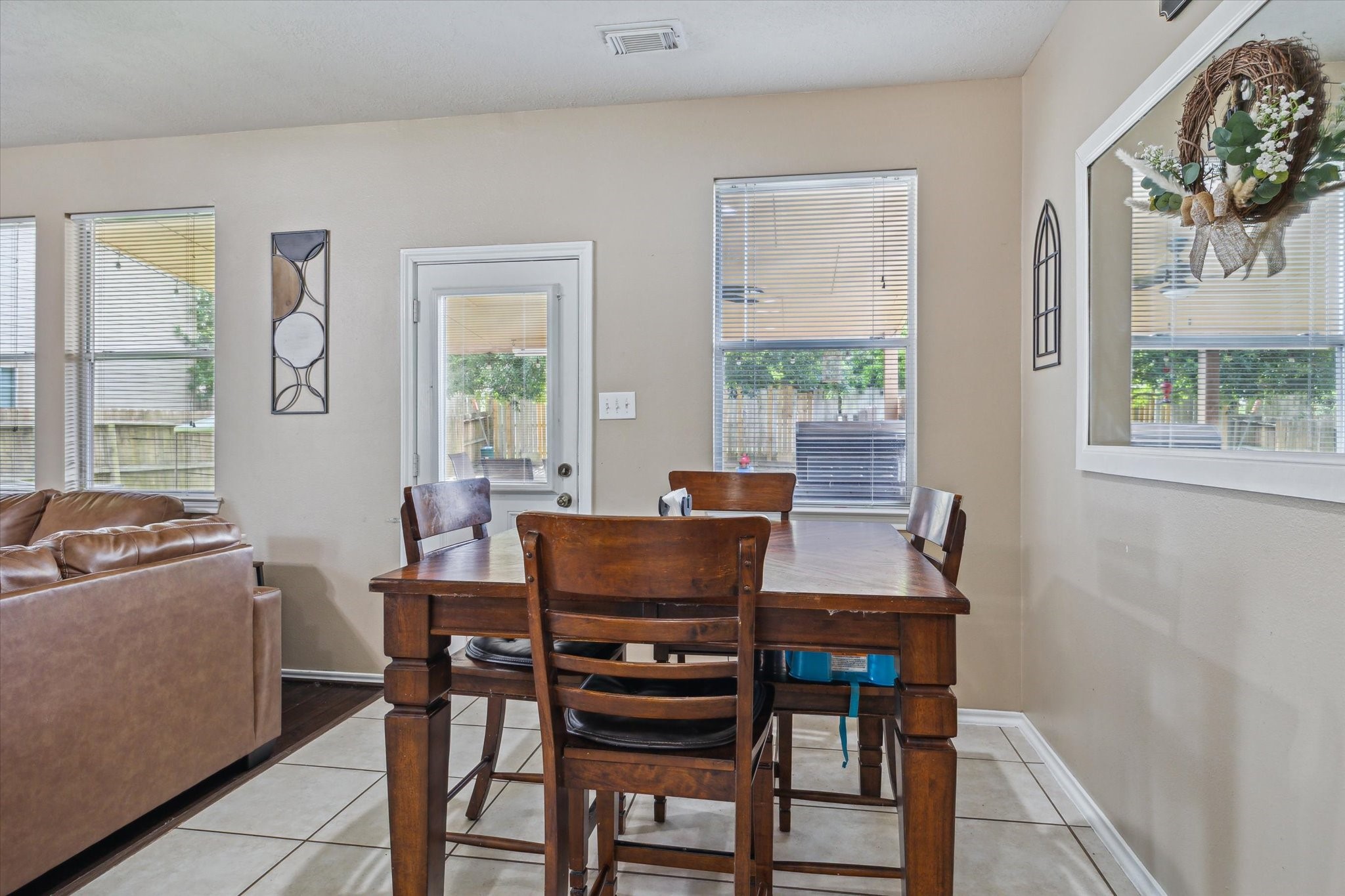 225 Drake Run Lane Dickinson, TX 77539 - Photo 3 of 22 a view of a dining room with furniture a chandelier and wooden floor