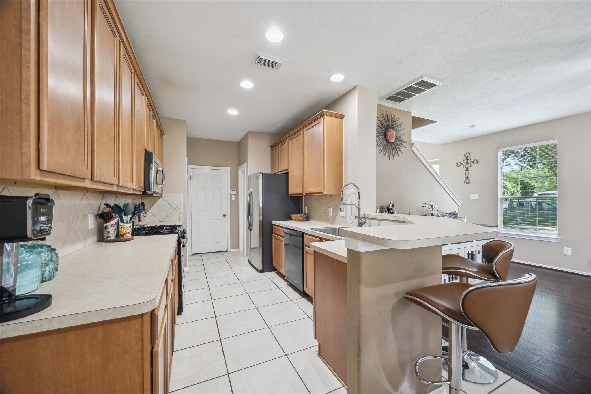 225 Drake Run Lane Dickinson, TX 77539 - Photo 6 of 22 a kitchen with a stove a sink a refrigerator and furniture