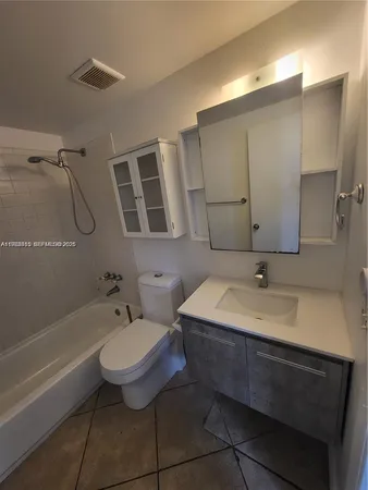 a bathroom with a sink toilet a mirror and shower