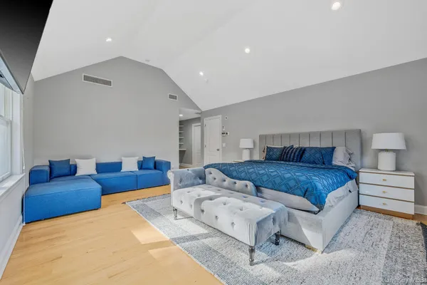 a bedroom with a large bed and couch