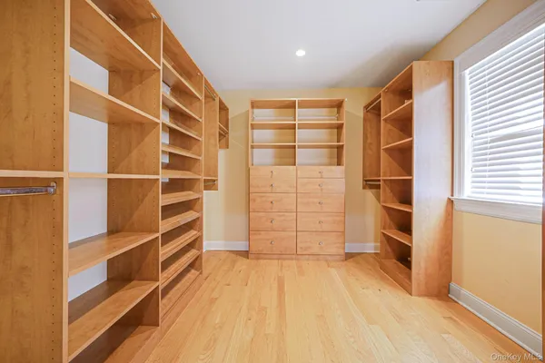 a view of walk in closet with empty racks