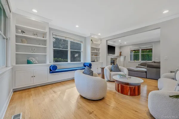 a living room with furniture a window and a dining table