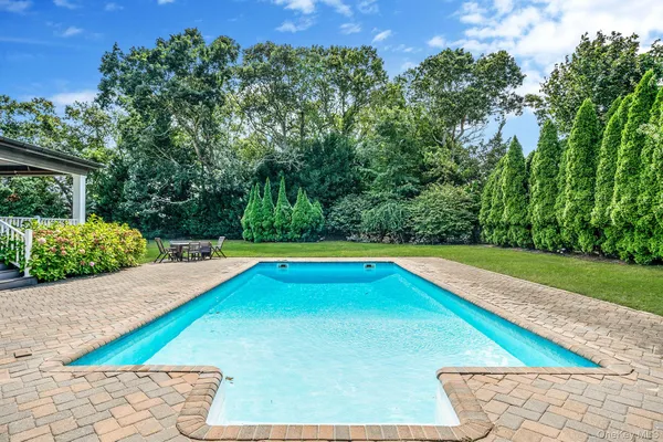a view of a backyard with swimming pool