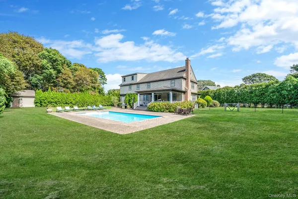 a view of house with yard and green space