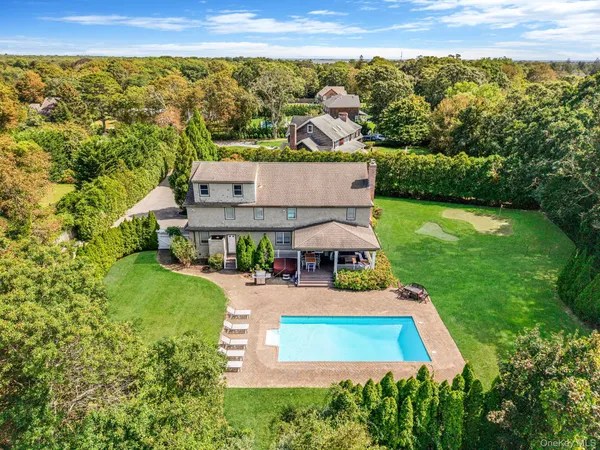 an aerial view of a house with a garden and trees