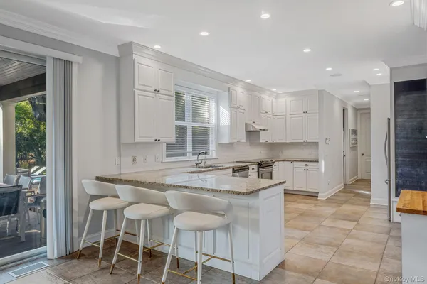 a kitchen with stainless steel appliances granite countertop a sink and cabinets