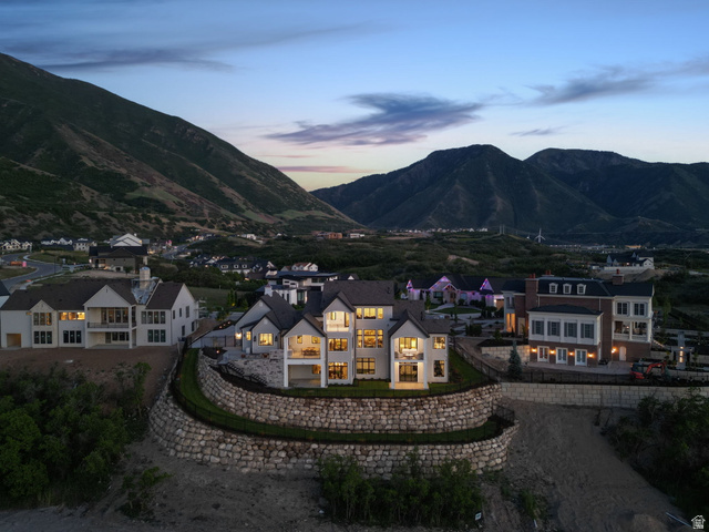 115 East Hidden Ridge Lane, Unit 42 Mapleton, UT 84664 - Photo 89 of 103 Luxurious residence featuring a multi-level stone retaining wall, multiple balconies, a covered patio, and large windows