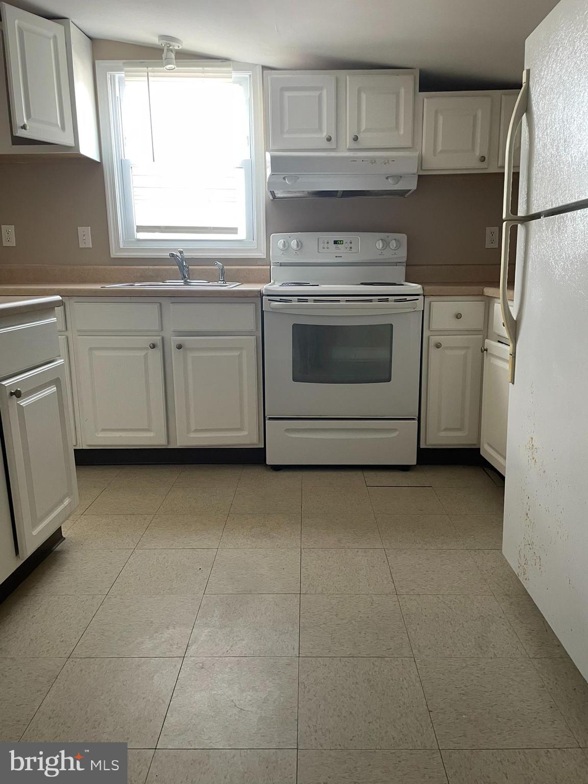 221 Chester Avenue, Unit A Moorestown, NJ 08057 - Photo 11 of 13 a kitchen with a stove sink and refrigerator