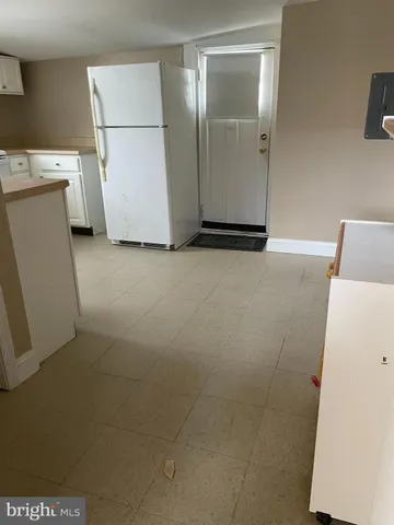 a view of storage and utility room with a refrigerator