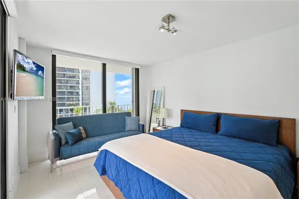 a bedroom with a large bed and a window
