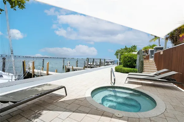 a swimming pool with outdoor seating