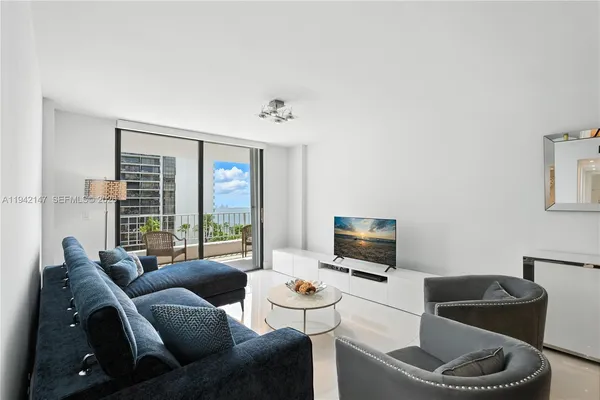 a living room with furniture and a flat screen tv