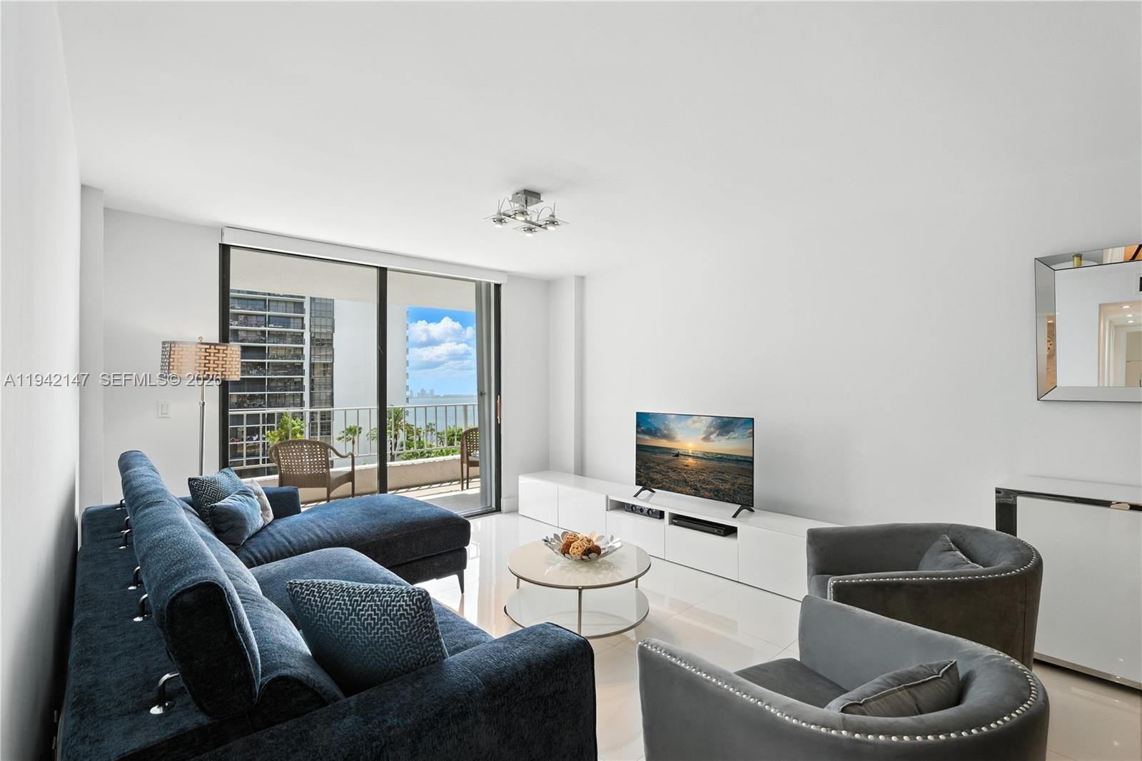 200 Southeast 15th Road, Unit 9I Miami, FL 33129 - Photo 7 of 24 a living room with furniture and a flat screen tv