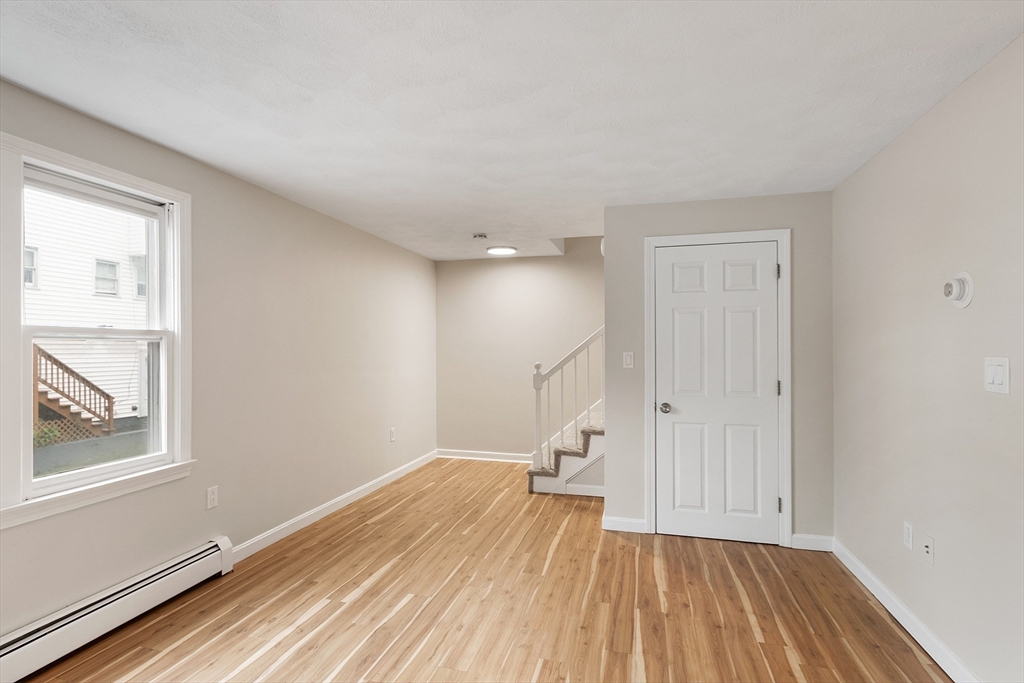 21 Crescent Street, Unit D Lawrence, MA 01841 - Photo 11 of 25 a view of a room with wooden floor and windows