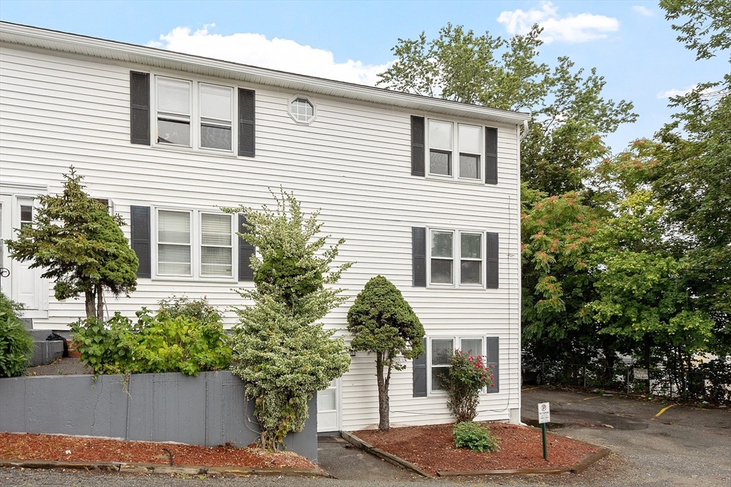 21 Crescent Street, Unit D Lawrence, MA 01841 - Photo 2 of 25 a house that has a tree in front of the house