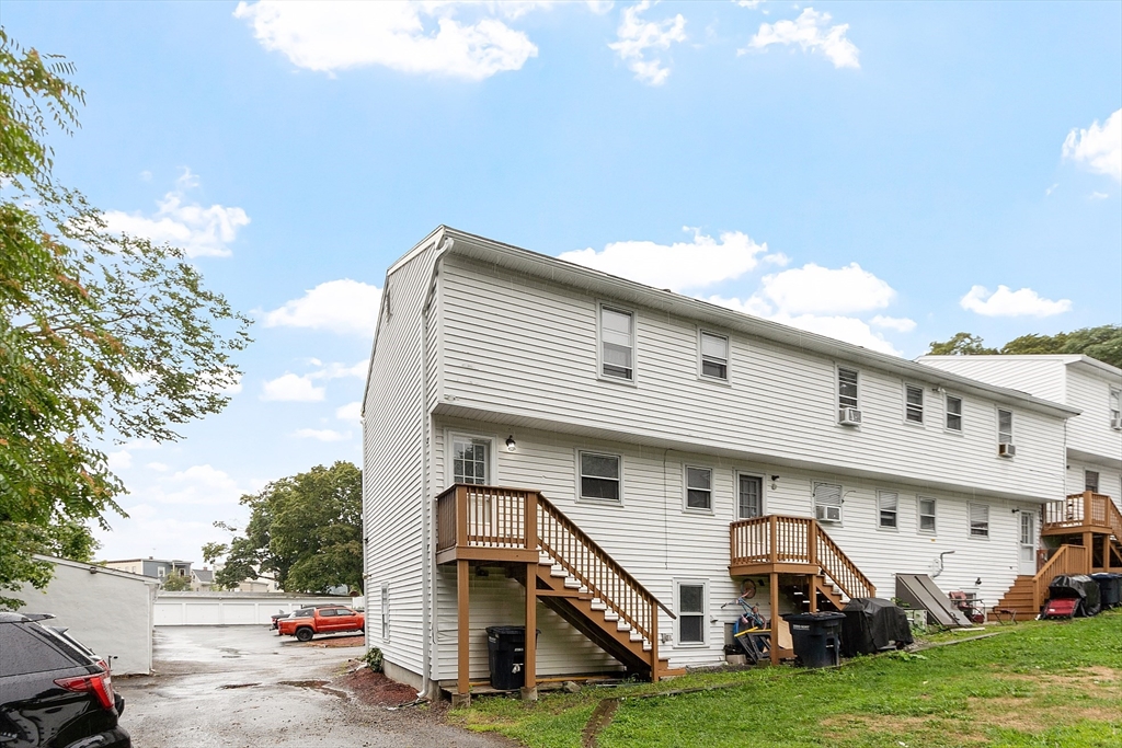 21 Crescent Street, Unit D Lawrence, MA 01841 - Photo 4 of 25 a view of a house with a yard