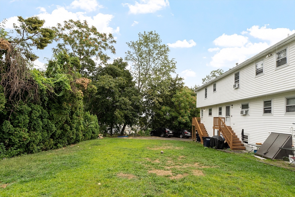 21 Crescent Street, Unit D Lawrence, MA 01841 - Photo 5 of 25 a view of a house with backyard