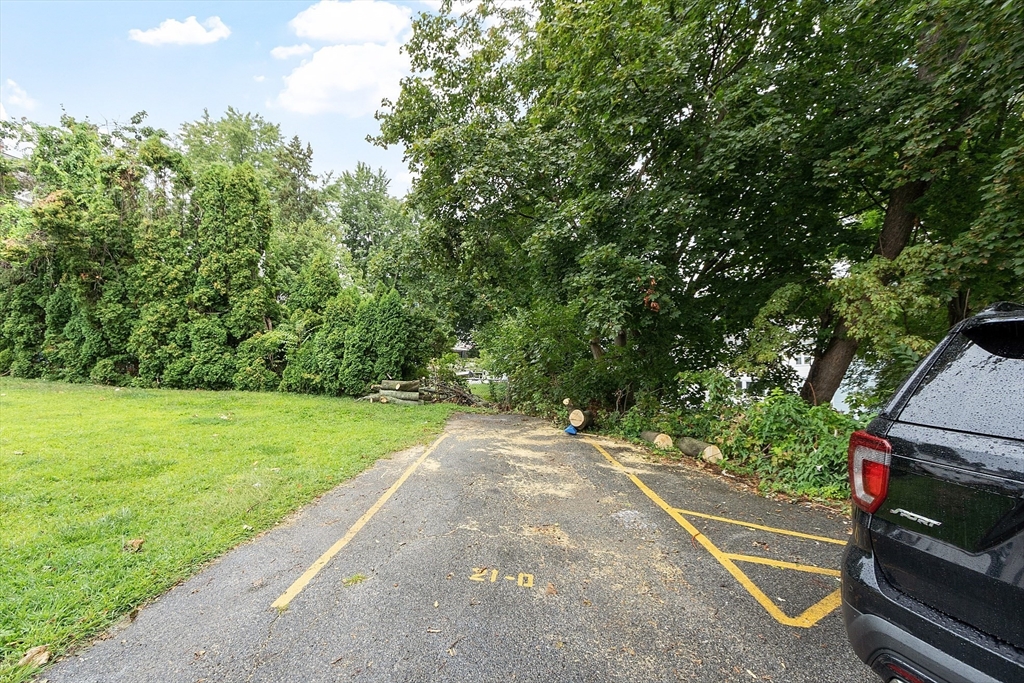 21 Crescent Street, Unit D Lawrence, MA 01841 - Photo 7 of 25 a backyard of a house with lots of green space
