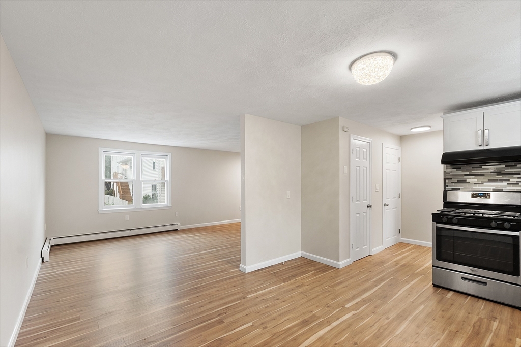 21 Crescent Street, Unit D Lawrence, MA 01841 - Photo 10 of 25 a view of kitchen with wooden floor electronic appliances and window