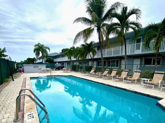 a view of a swimming pool with a table and chairs
