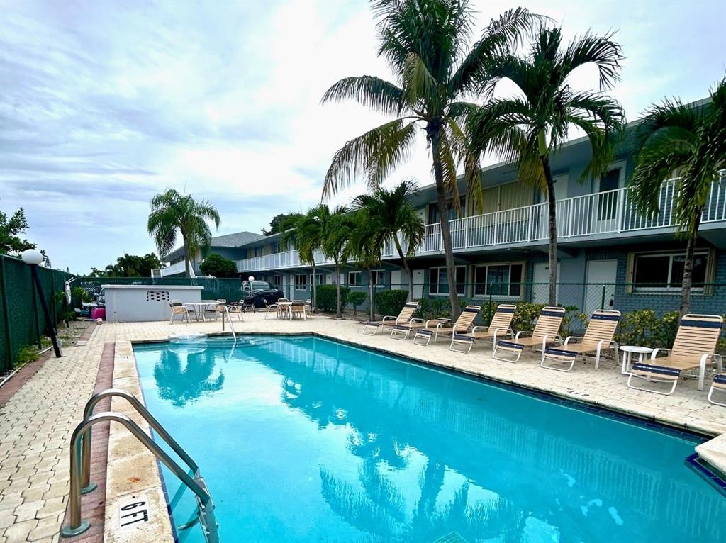 a view of a swimming pool with a table and chairs