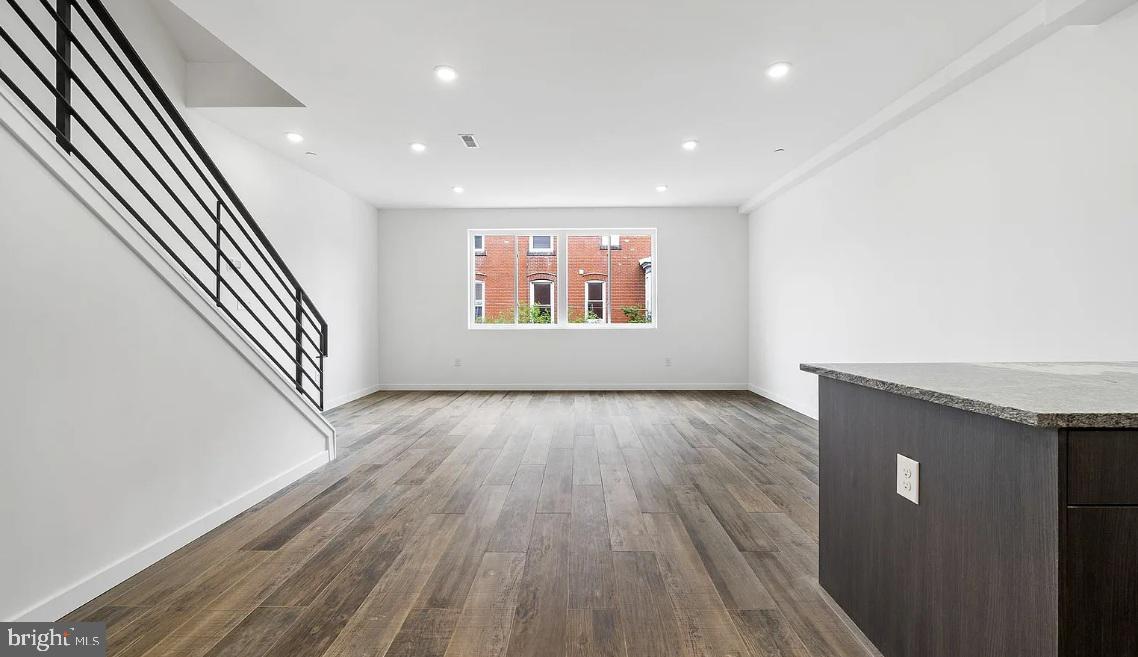 300 Budd Street, Unit B2 Philadelphia, PA 19104 - Photo 2 of 23 an entryway in a hall with wooden floor and a window