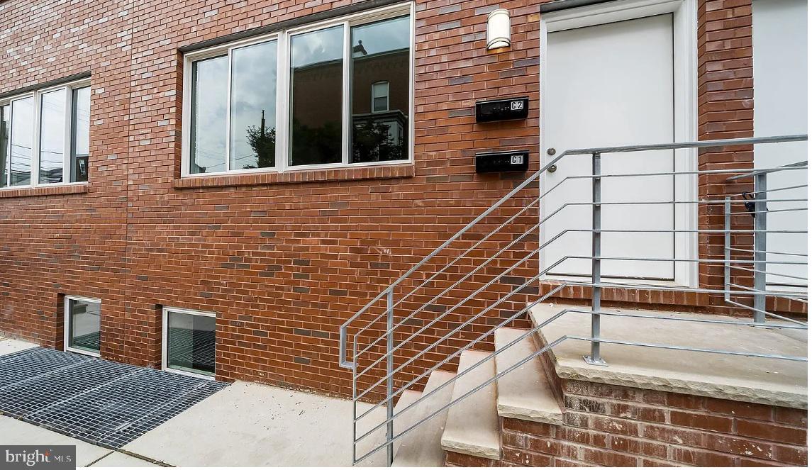 300 Budd Street, Unit B2 Philadelphia, PA 19104 - Photo 5 of 23 a front view of a house with a yard