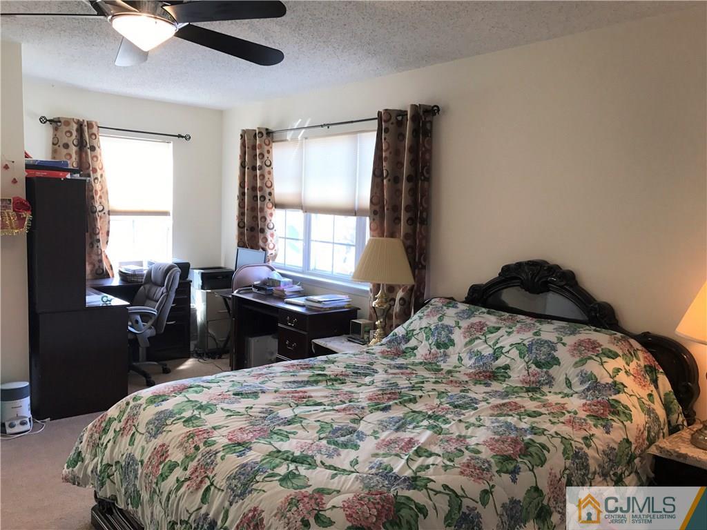 82 Orion Road, Unit 82 Piscataway, NJ 08854 - Photo 12 of 13 a bed sitting in a bedroom next to a window