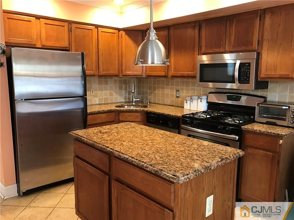 82 Orion Road, Unit 82 Piscataway, NJ 08854 - Photo 3 of 13 a kitchen with stainless steel appliances wooden cabinets and a sink