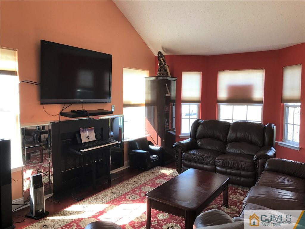 82 Orion Road, Unit 82 Piscataway, NJ 08854 - Photo 6 of 13 a living room with furniture and a flat screen tv