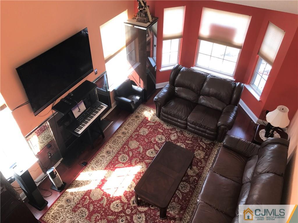 82 Orion Road, Unit 82 Piscataway, NJ 08854 - Photo 7 of 13 a living room with furniture and a flat screen tv