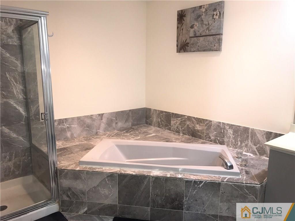 82 Orion Road, Unit 82 Piscataway, NJ 08854 - Photo 9 of 13 a bathroom with a bathtub