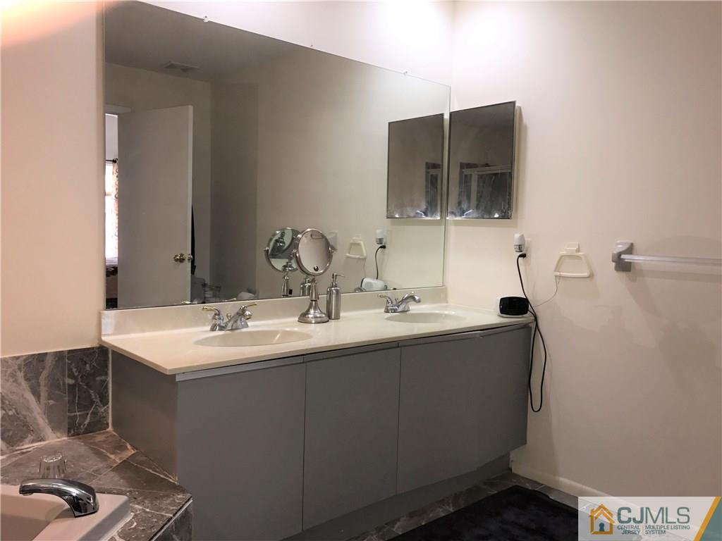 82 Orion Road, Unit 82 Piscataway, NJ 08854 - Photo 10 of 13 a bathroom with a sink and a mirror
