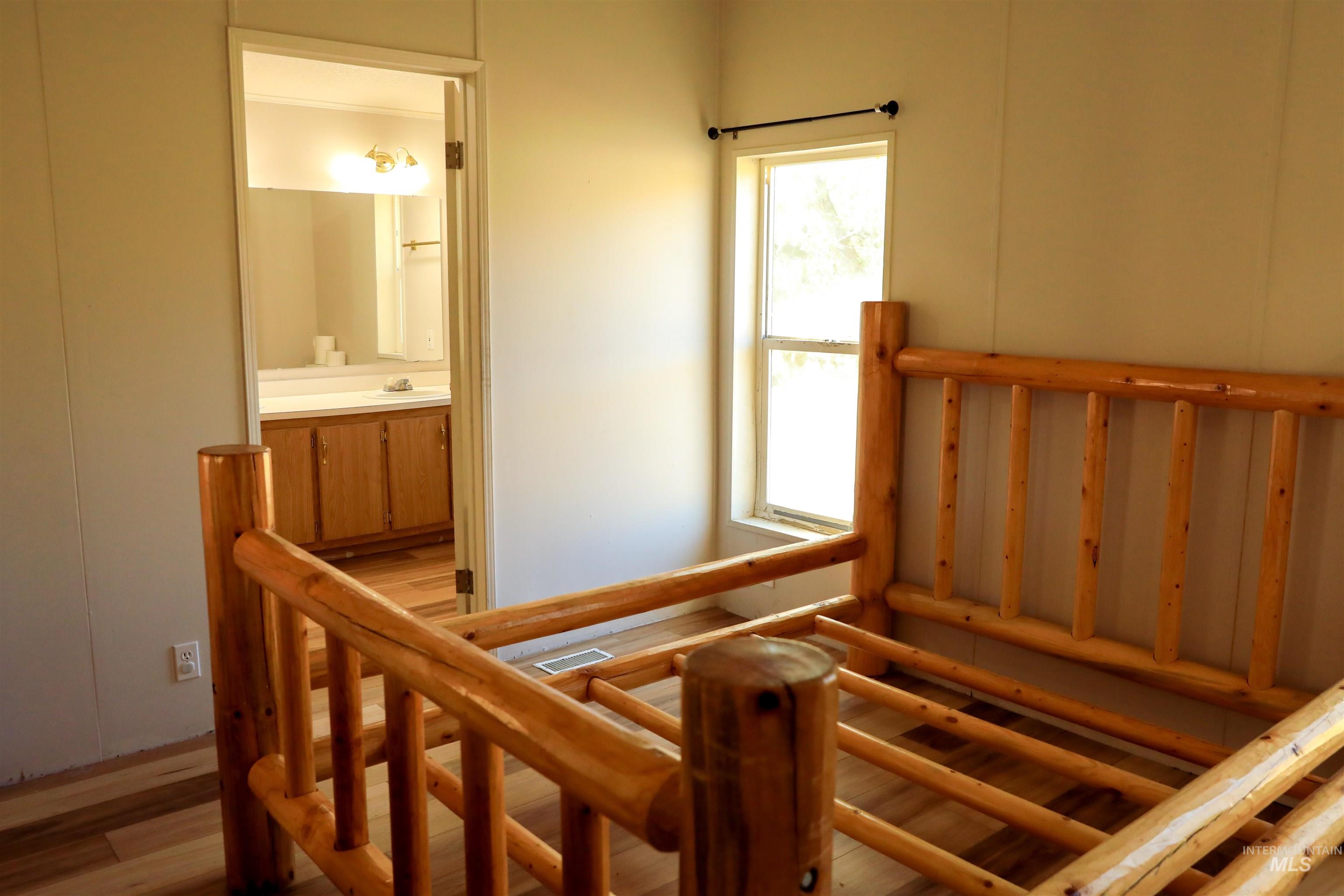 1550 Thousand Springs Road Weiser, ID 83672 - Photo 15 of 42 Stairway with wood finished floors
