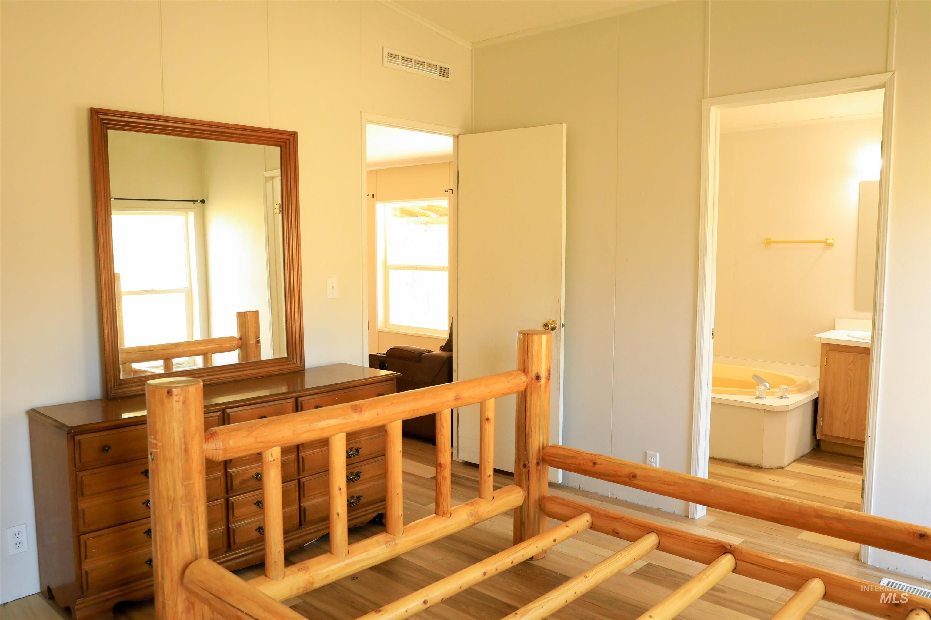 1550 Thousand Springs Road Weiser, ID 83672 - Photo 16 of 42 Bedroom with light wood-style floors and connected bathroom