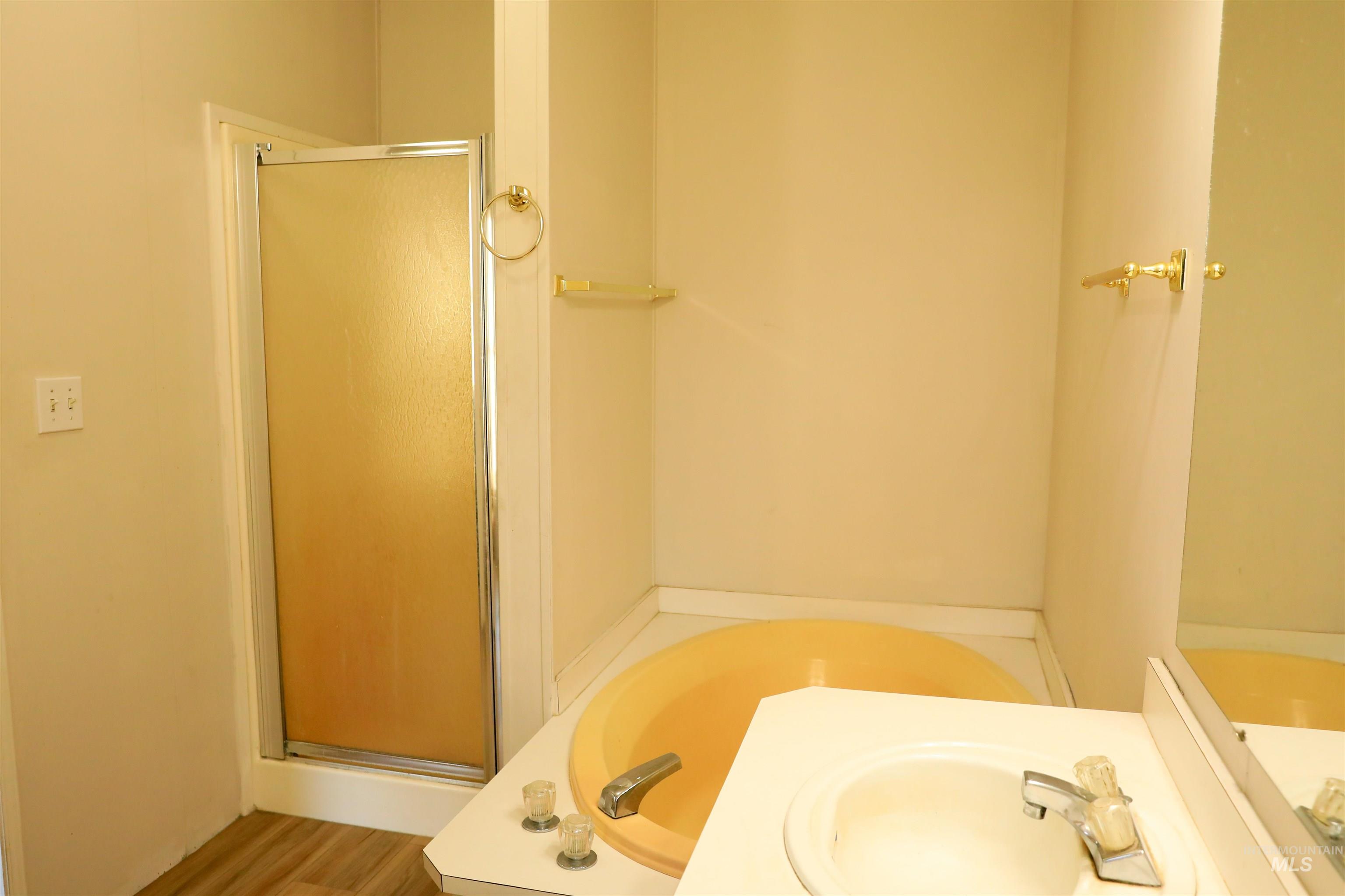 1550 Thousand Springs Road Weiser, ID 83672 - Photo 17 of 42 Bathroom with a shower stall, a bath, and vanity