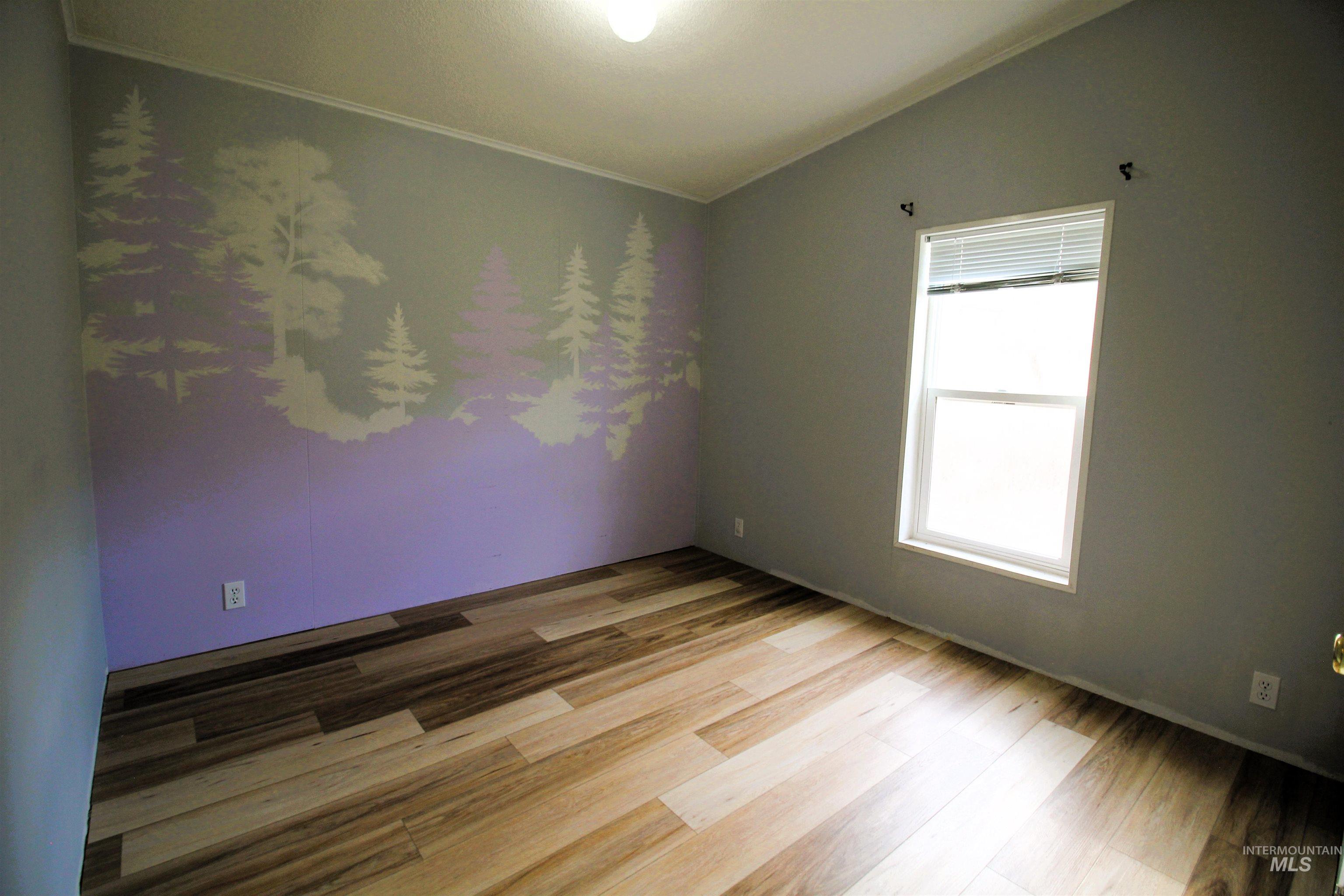1550 Thousand Springs Road Weiser, ID 83672 - Photo 21 of 42 Empty room featuring light wood finished floors and vaulted ceiling