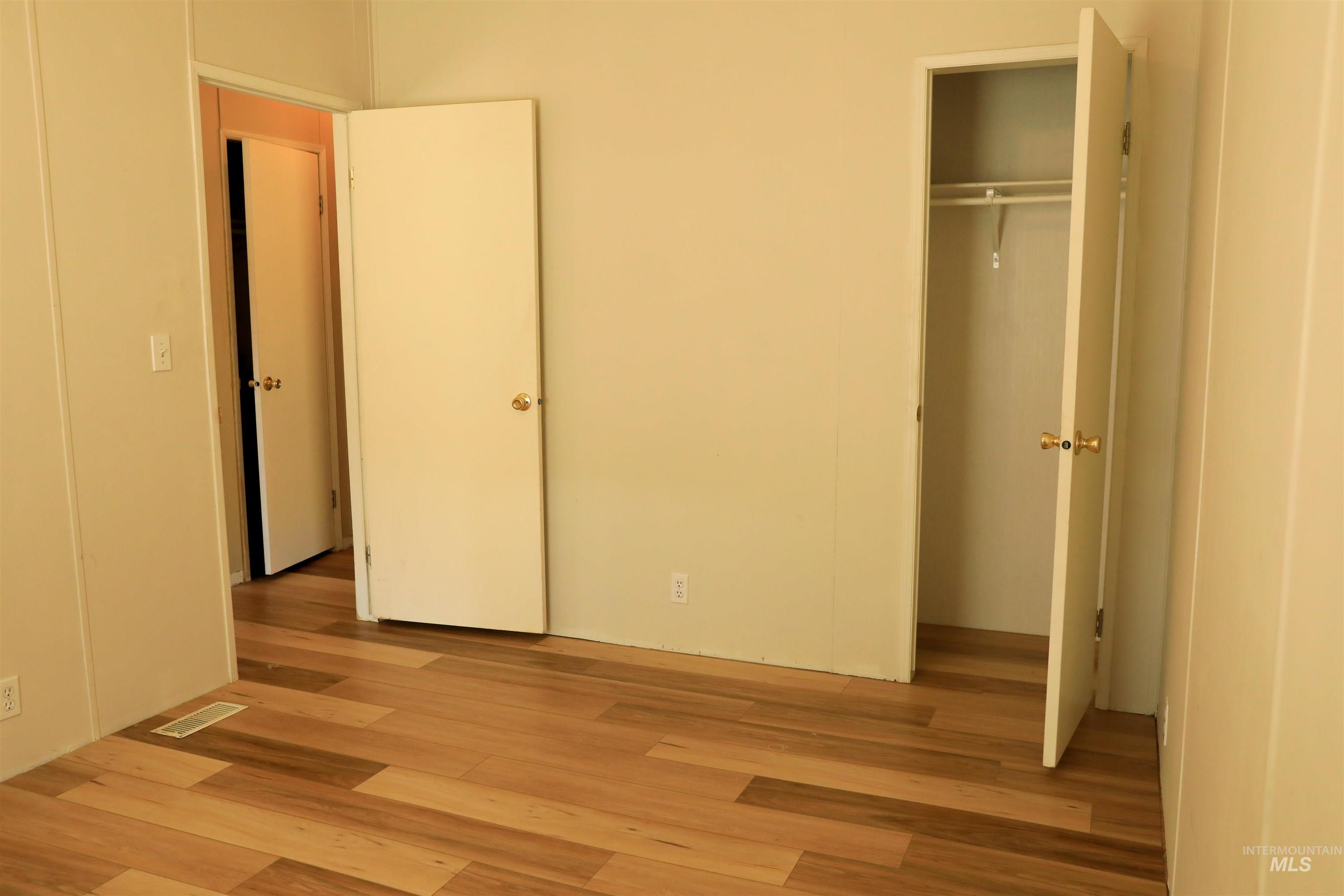 1550 Thousand Springs Road Weiser, ID 83672 - Photo 22 of 42 Unfurnished bedroom featuring light wood-style flooring and a closet
