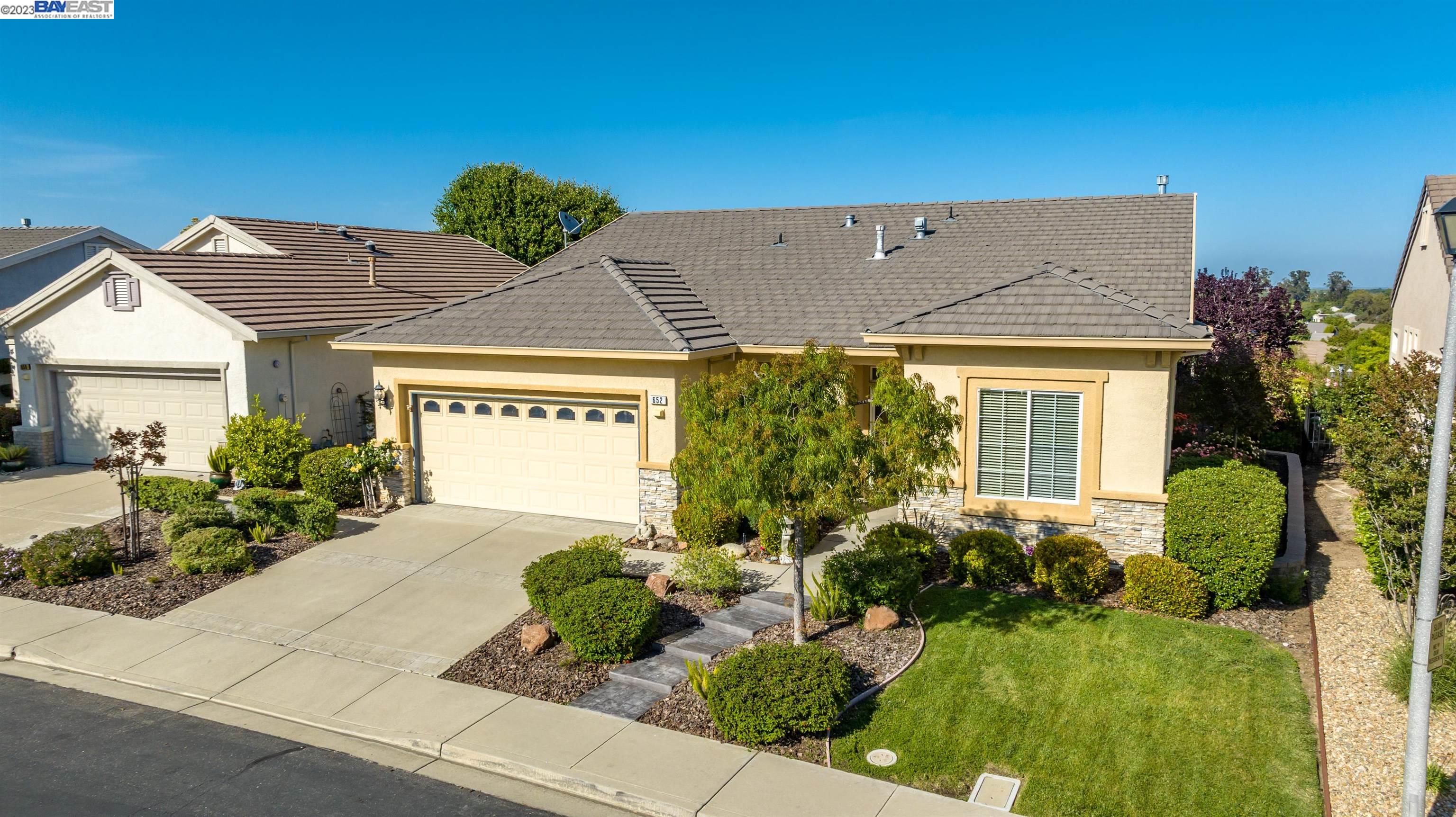a front view of a house with garden