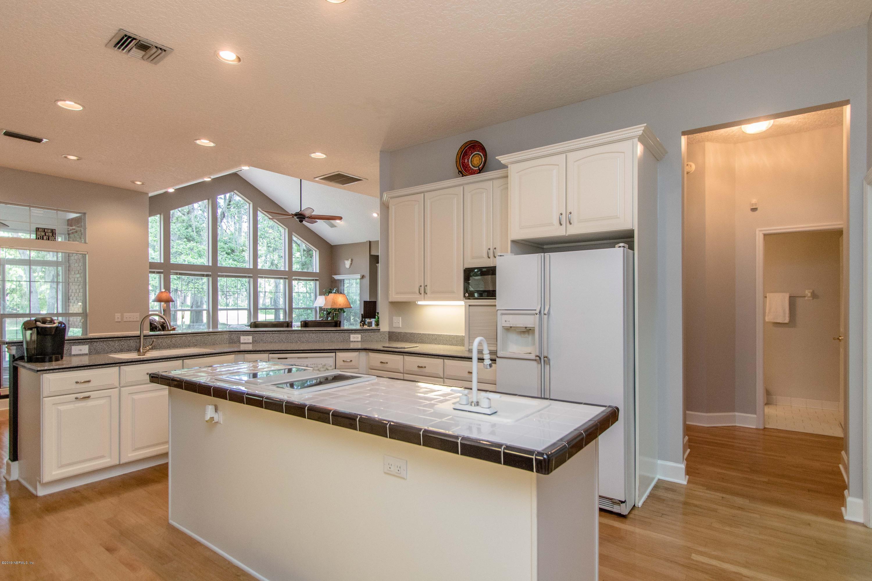 1944 Salt Myrtle Lane Fleming Island, FL 32003 - Photo 18 of 76 a kitchen with stainless steel appliances granite countertop a sink and a stove