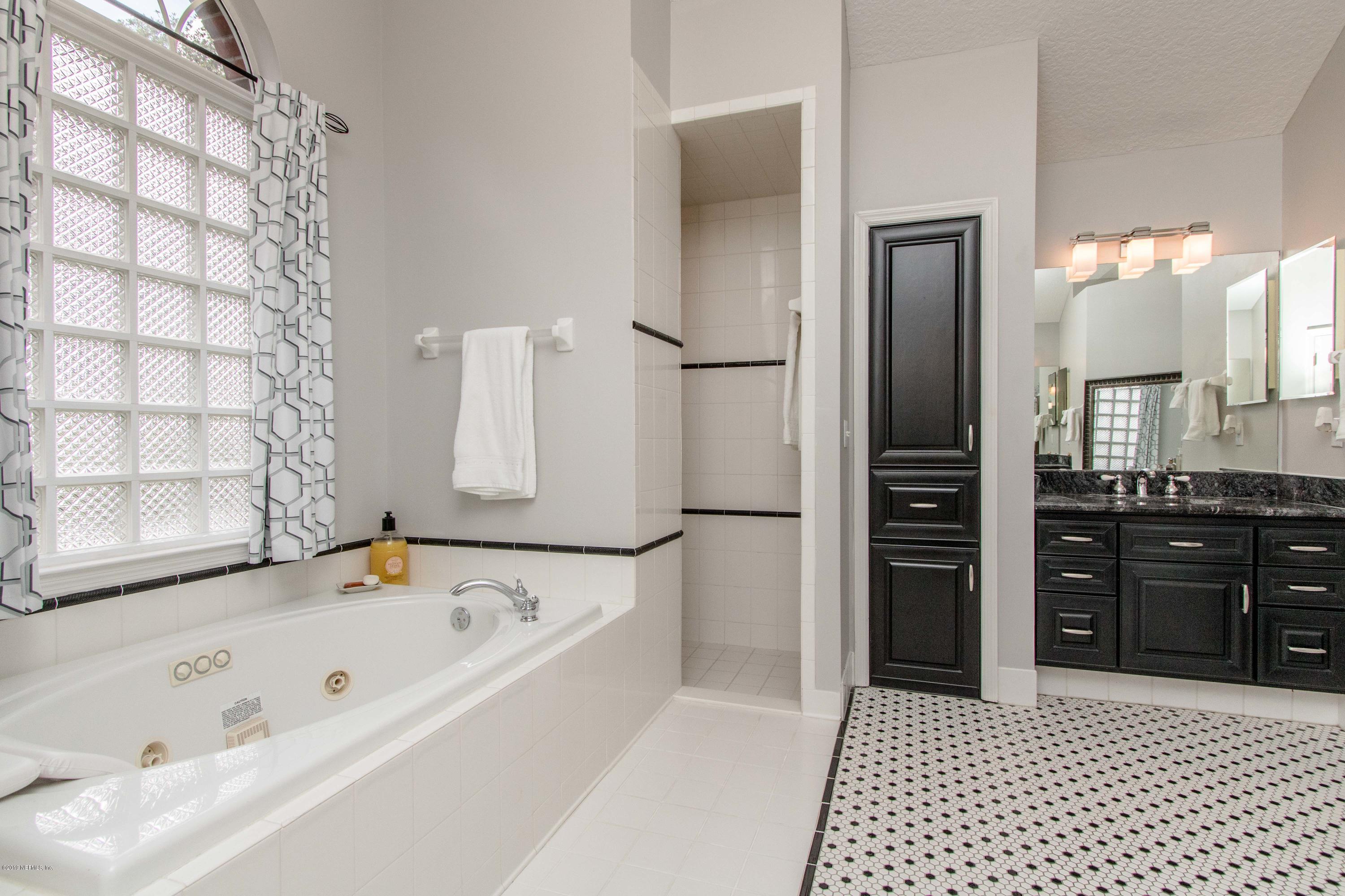 1944 Salt Myrtle Lane Fleming Island, FL 32003 - Photo 27 of 76 a bathroom with a bathtub and a shower