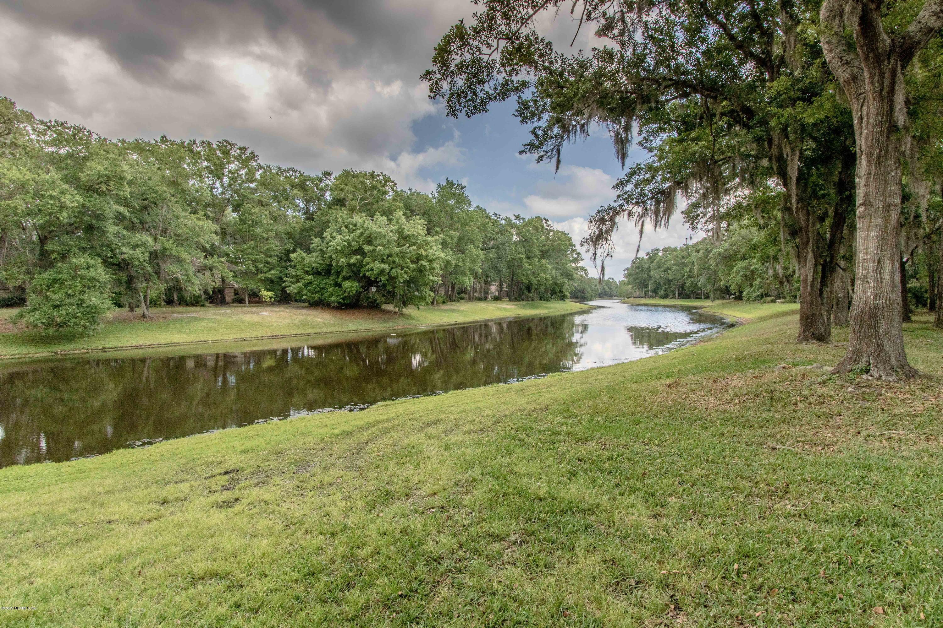 1944 Salt Myrtle Lane Fleming Island, FL 32003 - Photo 45 of 76 a view of a lake with a yard