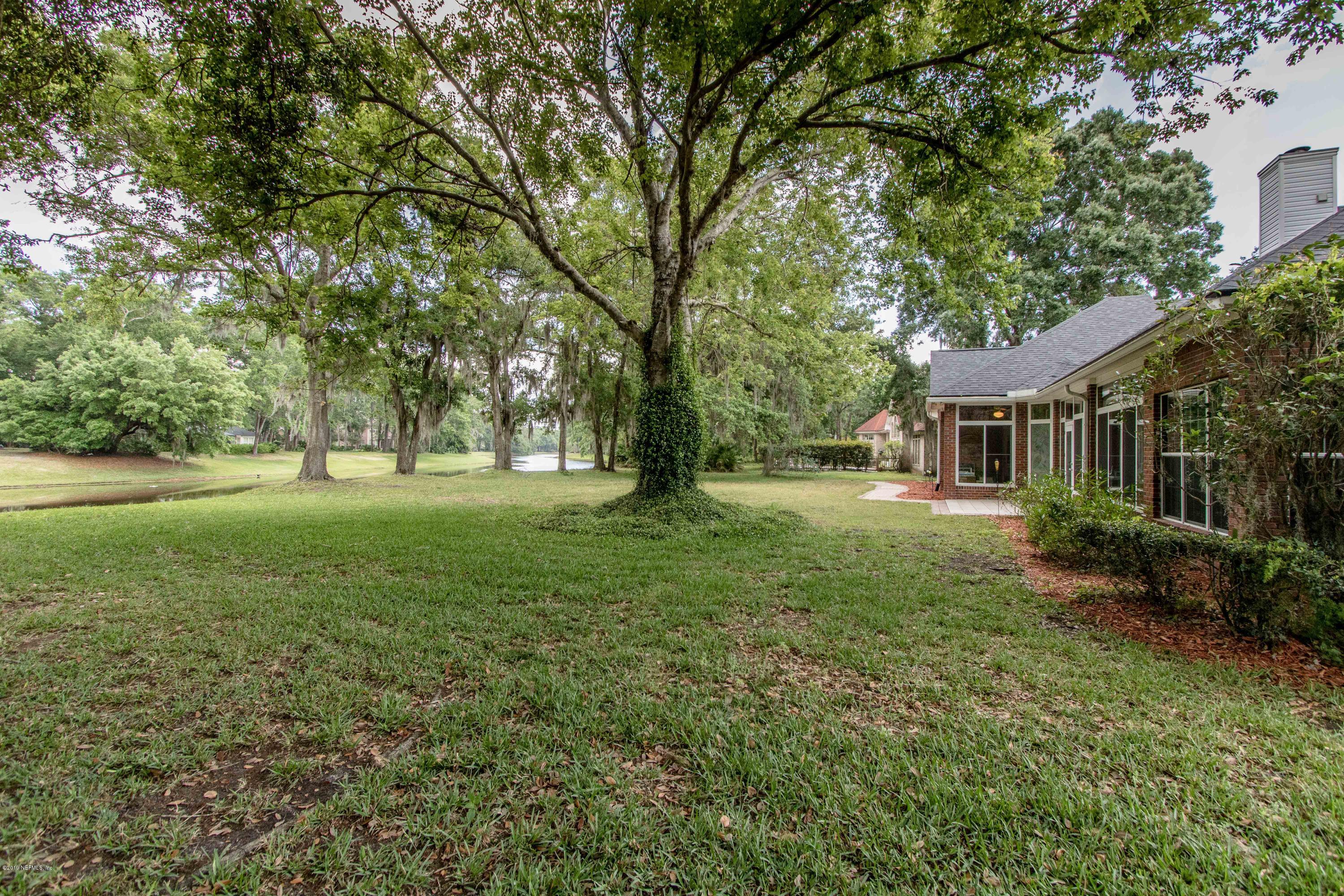 1944 Salt Myrtle Lane Fleming Island, FL 32003 - Photo 46 of 76 a view of a house with yard and tree s