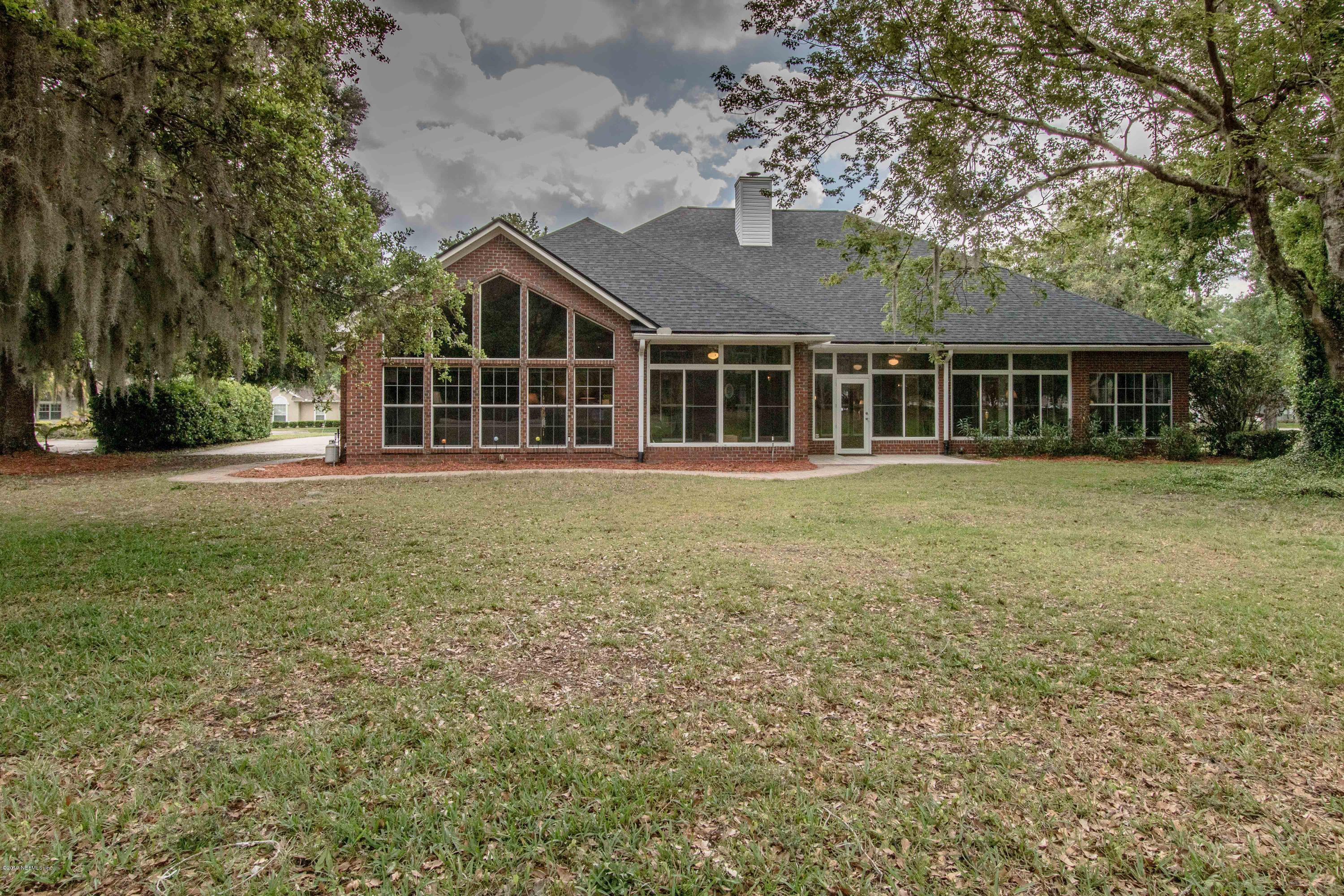 1944 Salt Myrtle Lane Fleming Island, FL 32003 - Photo 48 of 76 front view of a house with a yard