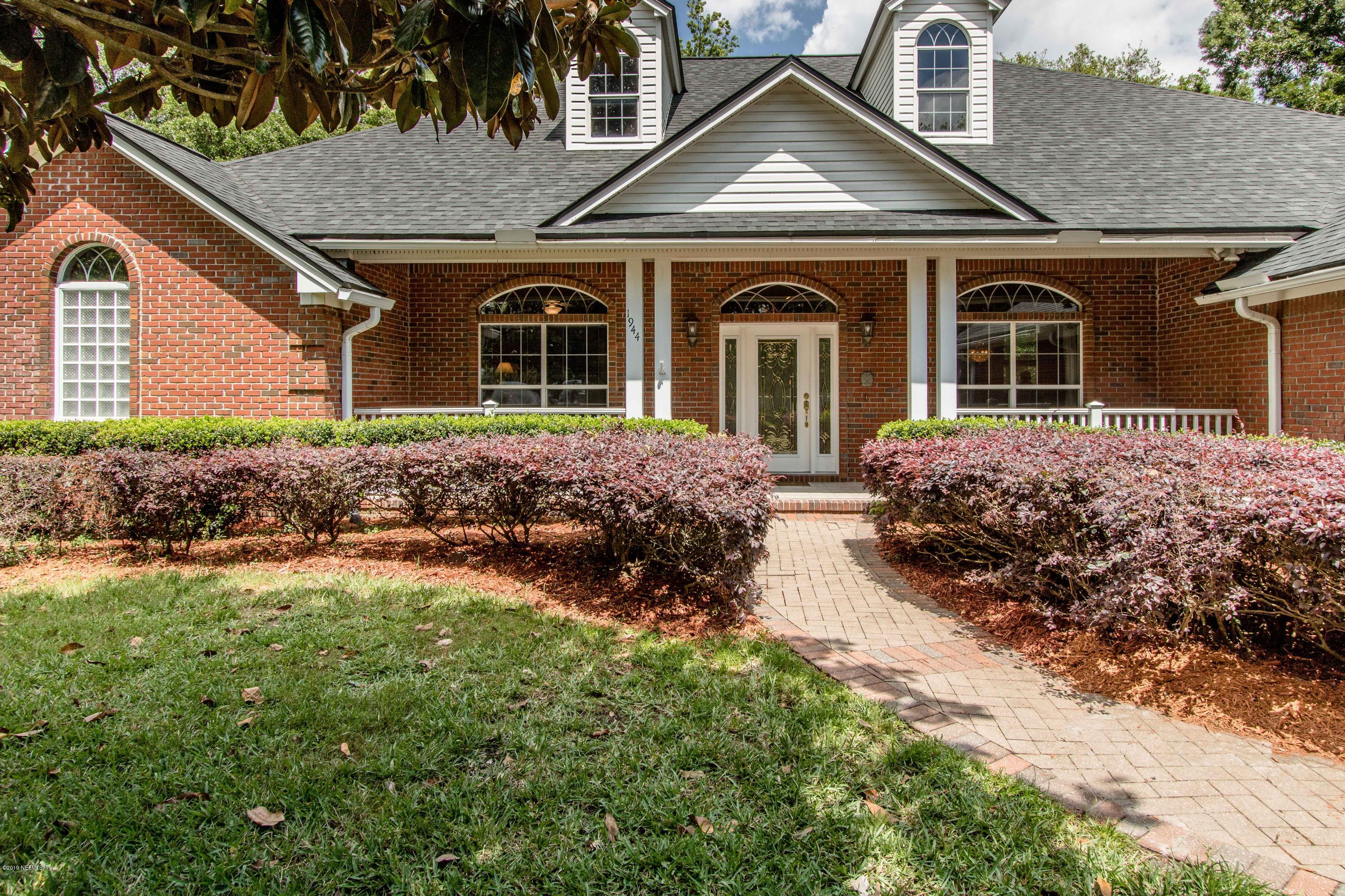 1944 Salt Myrtle Lane Fleming Island, FL 32003 - Photo 6 of 76 a front view of a house with a yard
