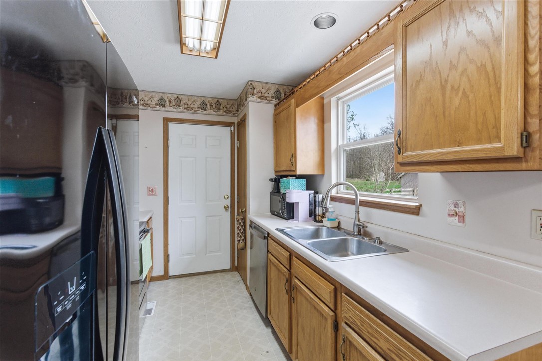 8747 Waynes Way Blanchester, OH 45107 - Photo 10 of 40 This functional kitchen features ample cabinetry and a bright window overlooking the natural surroundings.