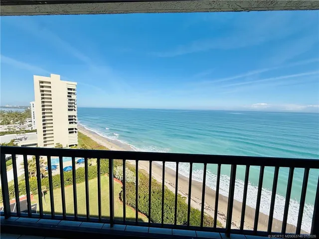 a bathroom with a granite countertop toilet sink and mirror