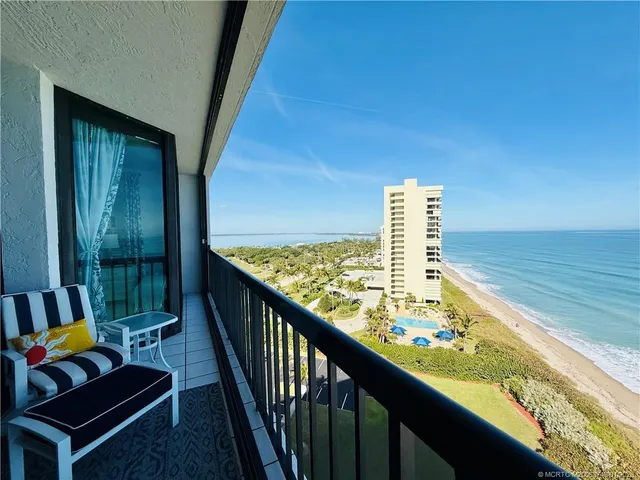 a view of a garage with table and chairs under an umbrella